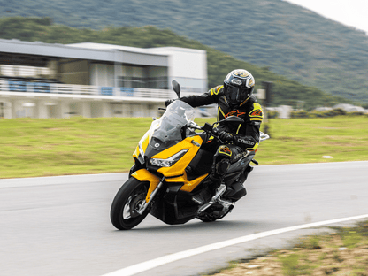 Person driving the Calypso Xplorer motorcycle on the road.